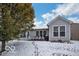 View of a backyard patio with outdoor seating, surrounded by a snowy landscape at 13982 Avalon Blvd, Fishers, IN 46037