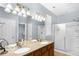 Bright bathroom with double sinks, modern lighting, and a separate shower at 13982 Avalon Blvd, Fishers, IN 46037