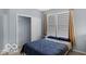 Comfortable bedroom featuring modern window blinds and a closet with sliding doors at 13982 Avalon Blvd, Fishers, IN 46037