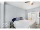 Bedroom featuring a large bed, ceiling fan and bathroom access at 13982 Avalon Blvd, Fishers, IN 46037