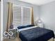 Simple bedroom with a blue comforter and natural light at 13982 Avalon Blvd, Fishers, IN 46037