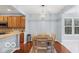 Dining area with a wooden table set, open to a modern kitchen with stainless steel appliances at 13982 Avalon Blvd, Fishers, IN 46037