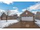 Charming home with a brick facade, two-car garage, and a snowy front yard at 13982 Avalon Blvd, Fishers, IN 46037