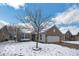 Charming home with a brick facade, two-car garage, and a snowy front yard at 13982 Avalon Blvd, Fishers, IN 46037