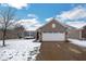 Charming home with a brick facade, two-car garage, and a snowy front yard at 13982 Avalon Blvd, Fishers, IN 46037