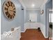 Entryway featuring hardwood floors, paneled wainscoting and a view of a cozy bedroom at 13982 Avalon Blvd, Fishers, IN 46037