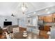 Dining area with a wooden table set, open to a modern living room and kitchen at 13982 Avalon Blvd, Fishers, IN 46037