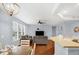 Open-concept living room and kitchen features wood floors and natural light at 13982 Avalon Blvd, Fishers, IN 46037
