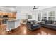 Open-concept living room and kitchen features wood floors and natural light at 13982 Avalon Blvd, Fishers, IN 46037