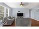 Inviting living room featuring hardwood floors, a ceiling fan, and a comfortable gray sofa at 13982 Avalon Blvd, Fishers, IN 46037