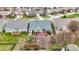 Aerial view of a landscaped backyard with garden, pergola, and small deck with beautiful garden features and trees at 14019 Colville Cir, Carmel, IN 46033