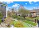 Beautifully landscaped backyard with a stone walkway, a manicured lawn, and mature trees at 14019 Colville Cir, Carmel, IN 46033