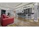Basement bar with modern lighting, hardwood floors and seating for hosting guests and entertaining at 14019 Colville Cir, Carmel, IN 46033