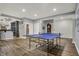 Finished basement with ping pong table and bar area creating a perfect entertainment space at 14019 Colville Cir, Carmel, IN 46033