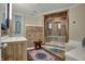 The elegant bathroom features a glass walk-in shower with a wooden bench and natural lighting at 14019 Colville Cir, Carmel, IN 46033