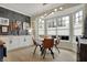 Bright breakfast nook features a modern light fixture, a round table, and large windows with white blinds at 14019 Colville Cir, Carmel, IN 46033