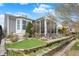 Well-maintained home exterior with a sunroom, back deck, lush landscaping, and a stone walkway at 14019 Colville Cir, Carmel, IN 46033