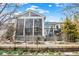 Back exterior view of home featuring a sunroom, deck area, manicured landscaping, and a well-maintained backyard at 14019 Colville Cir, Carmel, IN 46033