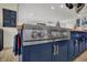 Modern kitchen features a BlueStar range, custom cabinetry, and butcher block countertops with ample space at 14019 Colville Cir, Carmel, IN 46033