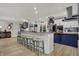 Modern kitchen featuring a large island with seating, stainless steel appliances, and ample storage space at 14019 Colville Cir, Carmel, IN 46033