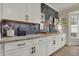 Bright kitchen with white cabinets, granite countertops, and a stylish backsplash is sure to please at 14019 Colville Cir, Carmel, IN 46033