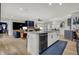 Spacious kitchen open to the living area, featuring a large island with a sink and modern appliances at 14019 Colville Cir, Carmel, IN 46033