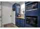 Well-equipped laundry room features custom blue cabinets with a microwave and modern oven at 14019 Colville Cir, Carmel, IN 46033