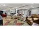 A spacious living room boasts hardwood floors and an oversized sectional with room for entertaining at 14019 Colville Cir, Carmel, IN 46033