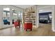 Bright living room featuring a curated library, glass doors to a sunroom, and comfortable furniture at 14019 Colville Cir, Carmel, IN 46033