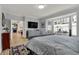Cozy main bedroom with wood floors offers natural light, an entertainment center, and easy access to the kitchen at 14019 Colville Cir, Carmel, IN 46033
