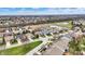 Aerial view of a neighborhood featuring a variety of homes with lawns, trees, and a scenic pond at 14019 Colville Cir, Carmel, IN 46033