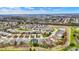 Aerial view featuring a well-planned community with diverse homes, a winding pond, and lush greenery at 14019 Colville Cir, Carmel, IN 46033