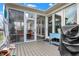 Bright sunroom featuring a screened-in design with a seating area, offering seamless indoor-outdoor living at 14019 Colville Cir, Carmel, IN 46033
