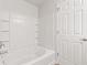 Bathroom featuring a white tub, shower, tile surround, and storage niches adding convenience at 14317 Banister Dr, Noblesville, IN 46060