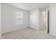 A bedroom featuring neutral carpet, a window, and a closet with white bi-fold doors at 14317 Banister Dr, Noblesville, IN 46060
