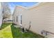 Home's exterior showcasing light siding, backyard access, and an adjacent grassy yard at 14317 Banister Dr, Noblesville, IN 46060