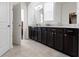 Modern bathroom features double sinks with granite countertops and dark wood cabinets at 1444 Waterleaf Dr, Westfield, IN 46074