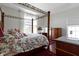 A beautiful primary bedroom featuring a canopy bed, light hardwood floors, and a view of the outdoors at 1444 Waterleaf Dr, Westfield, IN 46074