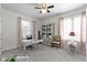 This bedroom includes a desk, ceiling fan and windows for natural light at 1444 Waterleaf Dr, Westfield, IN 46074