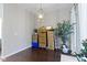 A dining room with hardwood floors, a chandelier, and various stored items against the wall at 1444 Waterleaf Dr, Westfield, IN 46074