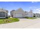Exterior shot of a two-car garage with a wide driveway and green lawns at 1444 Waterleaf Dr, Westfield, IN 46074