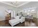 Bright living room features modern furniture, hardwood floors, and open-concept design to kitchen at 1444 Waterleaf Dr, Westfield, IN 46074