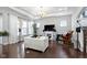 Bright living room featuring hardwood floors, modern furniture, and a view to stairs and windows at 1444 Waterleaf Dr, Westfield, IN 46074