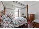 Primary bedroom featuring four-poster bed, dark wood floors, and large window at 1444 Waterleaf Dr, Westfield, IN 46074