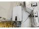 Interior image of a tankless hot water heater and pipes in basement at 1444 Waterleaf Dr, Westfield, IN 46074