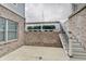 Backyard with brick wall, concrete patio and stairway with white railings at 1472 Windpump Way, Carmel, IN 46280