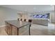 Open concept basement with a partial bar area and a large living room with multiple TVs for entertainment at 1472 Windpump Way, Carmel, IN 46280
