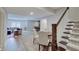 Open basement featuring a dining area, living room with comfortable seating, and stairs leading to the upper level at 1472 Windpump Way, Carmel, IN 46280