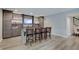 A finished basement bar area features sleek cabinetry, a built-in sink, and seating for four, perfect for entertaining at 1472 Windpump Way, Carmel, IN 46280