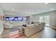 Cozy basement living room with a sectional sofa, area rug, and three mounted TVs for the ultimate entertainment experience at 1472 Windpump Way, Carmel, IN 46280